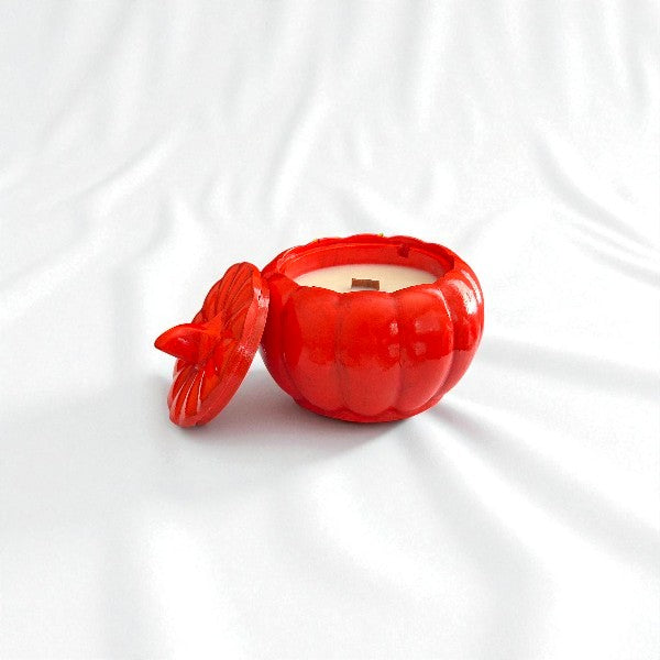 Red pumpkin-shaped container with a lid on a white background