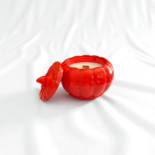 Red pumpkin-shaped container with a lid on a white background
